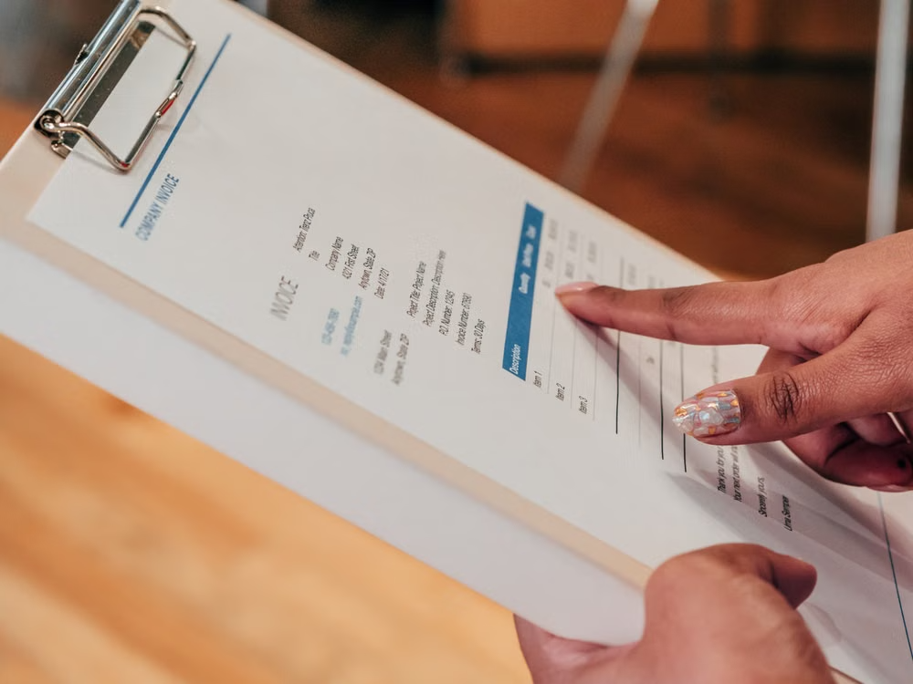 Itemized company invoice being reviewed